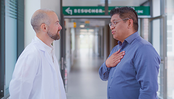 A doctor and relative talking at the hospital ward